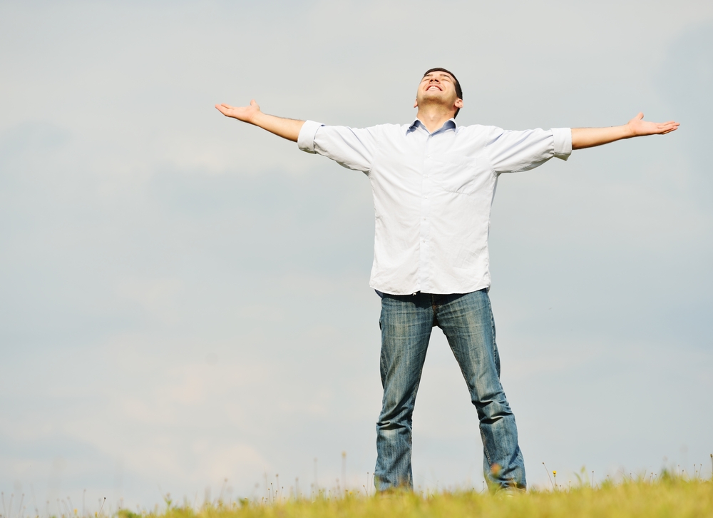 Young man having happy time in nature with copy space